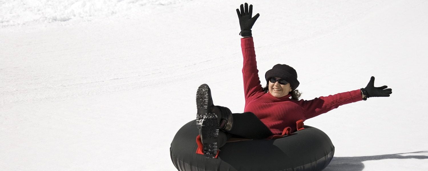 woman tubing in the snow