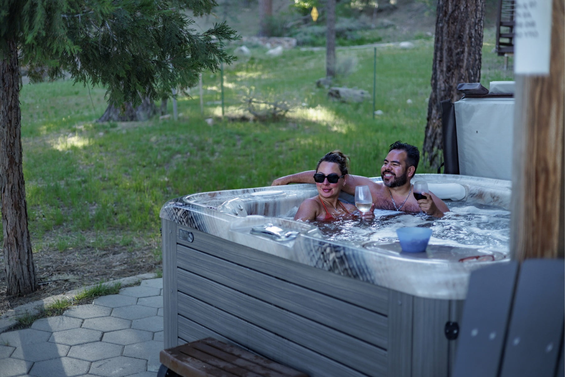 Two people Relax in private hot tub with lake views and enjoy the evening stars, family friendly atmosphere at Big Bear Lakefront Cabins